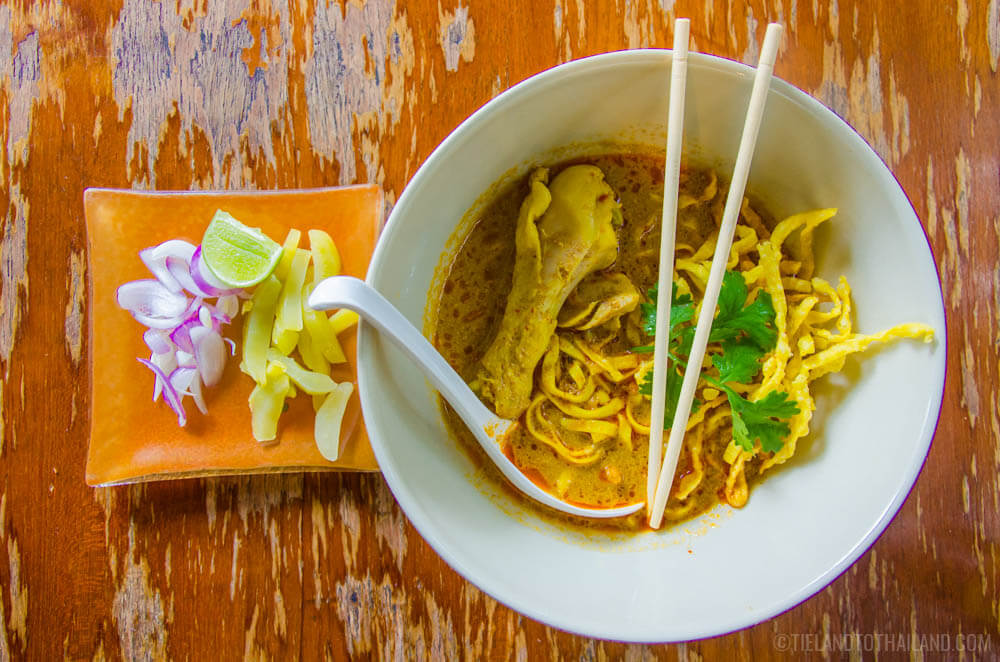 Bowl of khao soi gai, or Northern Thai yellow curry with chicken